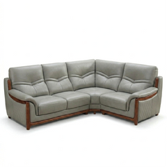 corner sofa with deep cushions, rounded arms and warm polished wooden side details — close view showing the cushion and su...