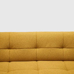 warm mustard rounded sofa with deep square cushioning and a soft textured finish — wide room view showing the complete sea...