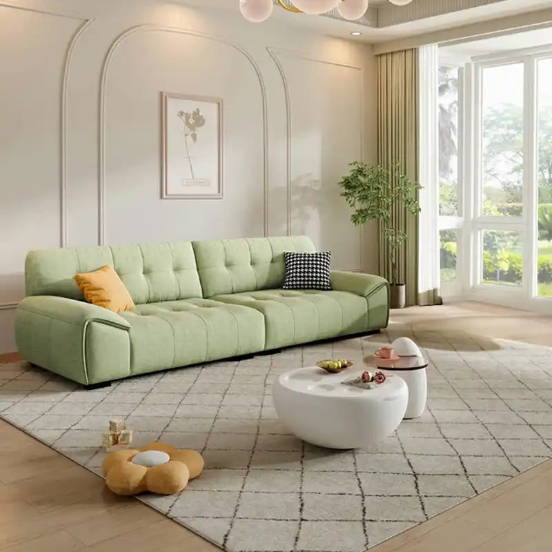 modern fabric sofa with clean square cushion details, soft arms and a simple balanced shape — front view in a bright livin...
