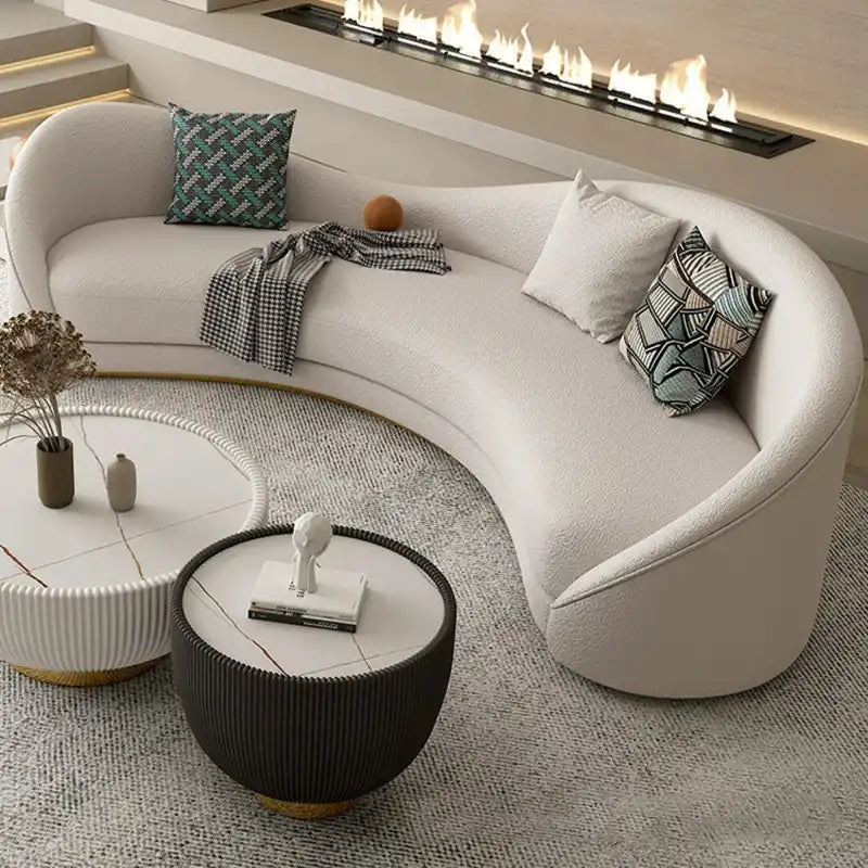 off white curved sofa with deep cushions, smooth rounded arms and soft textured fabric — front view in a bright living room