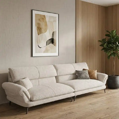 cream textured fabric sofa with curved arms, supportive back cushions and slim dark legs — front view in a bright living room