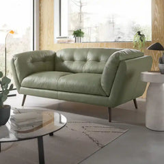 modern fabric sofa with rounded arms, soft cushions and slim raised legs — front view in a bright living room