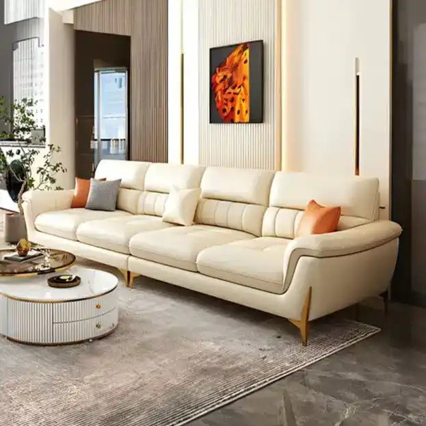 cream high back sofa with vertical cushion panels, rounded arms and slim gold finish legs — front view in a bright living...