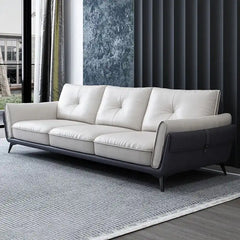 dual tone beige and charcoal fabric sofa with a soft cushioned back and deep seating — front view in a bright living room