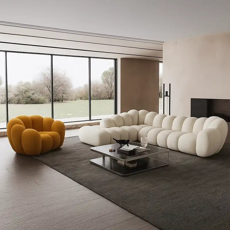 soft curved sofa with rounded cushion sections, a cloud like shape and a low relaxed base — front view in a bright living...