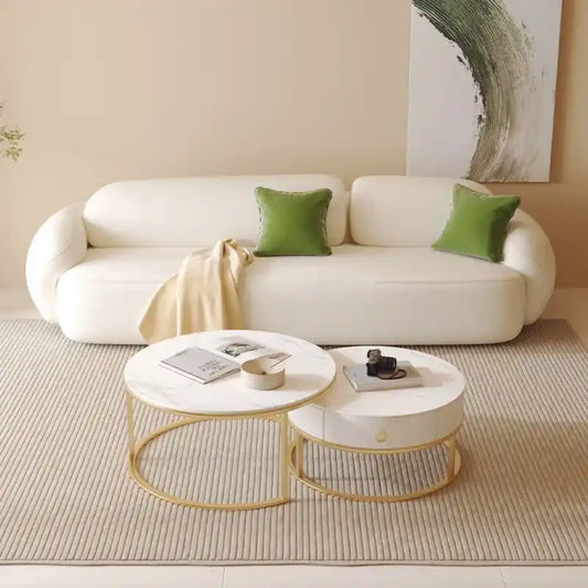 soft curved fabric sofa with cloud like cushions, wraparound arms and a low grounded base — angled view showing the full s...
