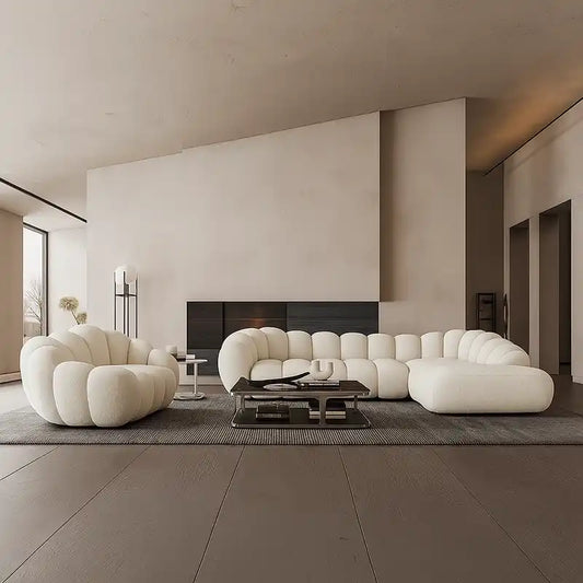 soft curved sofa with rounded cushion sections, a cloud like shape and a low relaxed base — angled view showing the full s...