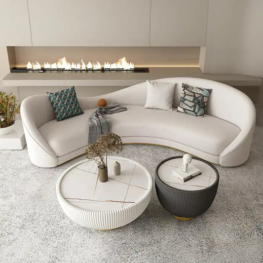 off white curved sofa with deep cushions, smooth rounded arms and soft textured fabric — angled view showing the full shap...