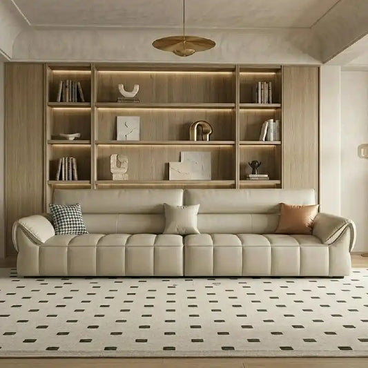 wide leatherette sofa with deep square cushioning and a low relaxed shape — angled view showing the full shape and cushions