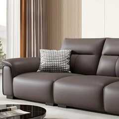 dark brown luxury sofa with broad pillow soft arms, cushioned back and detailed side panels — angled view showing the full...