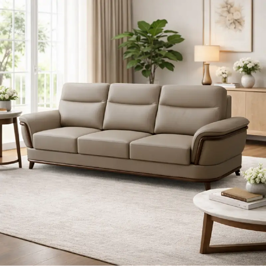 beige pure leather sofa with supportive back cushions, curved arms and refined wooden details — angled view showing the fu...