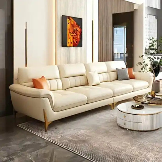 cream high back sofa with vertical cushion panels, rounded arms and slim gold finish legs — angled view showing the full s...
