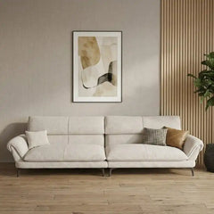 cream textured fabric sofa with curved arms, supportive back cushions and slim dark legs — angled view showing the full sh...