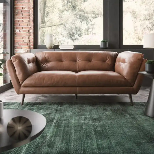 modern fabric sofa with rounded arms, soft cushions and slim raised legs — angled view showing the full shape and cushions