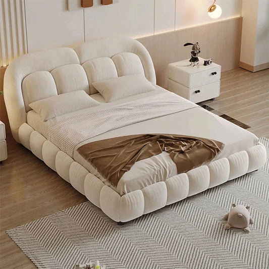 Full bed photo showing plush footboard, custom created to order, upholstered wood design