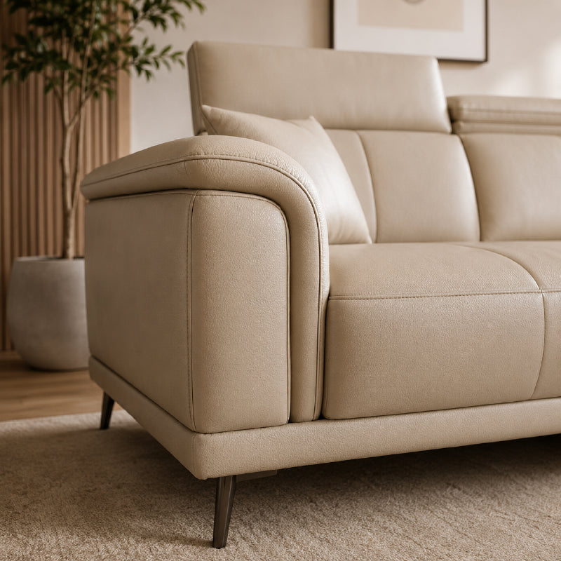 beige l shape sofa with adjustable head support, rounded arms and slim raised legs — front angle showing the back support...