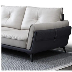 dual tone beige and charcoal fabric sofa with a soft cushioned back and deep seating — side angle showing the arms and rai...