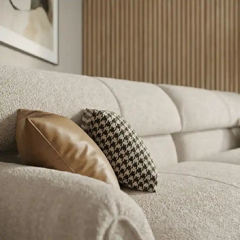 cream textured fabric sofa with curved arms, supportive back cushions and slim dark legs — side angle showing the arms and...
