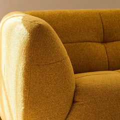 warm mustard rounded sofa with deep square cushioning and a soft textured finish — side angle showing the arms and raised...