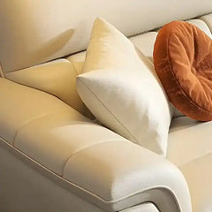 cream high back sofa with vertical cushion panels, rounded arms and slim gold finish legs — side angle showing the arms an...