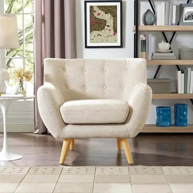 soft beige fabric sofa with rounded arms, buttoned back cushions and slim wooden legs — side angle showing the arms and ra...