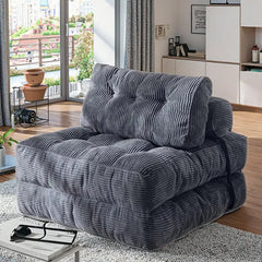 Folding sofa bed in soft ribbed fabric, with practical features for compact living spaces