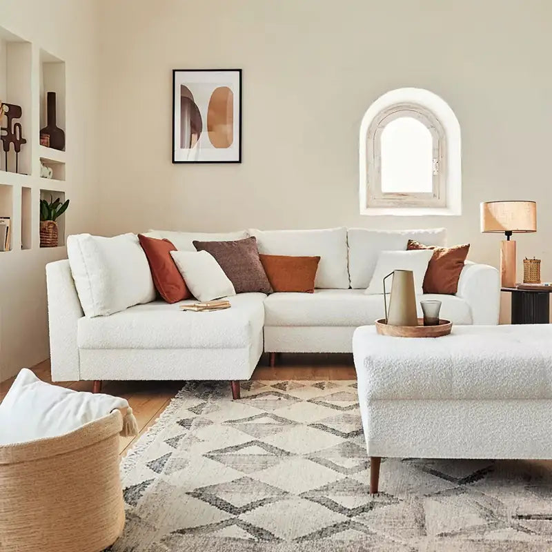 Sleeper sofa with a movable footstool, with practical features for compact living spaces
