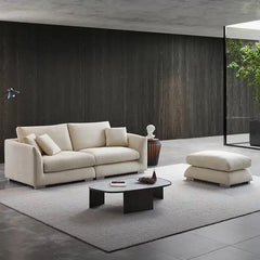 wide l shape fabric sofa with rounded arms, loose back cushions and deep comfortable seating — close view showing the cush...