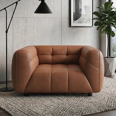 warm brown luxury sofa with deep square cushioning, rounded edges and a low relaxed shape — close view showing the cushion...