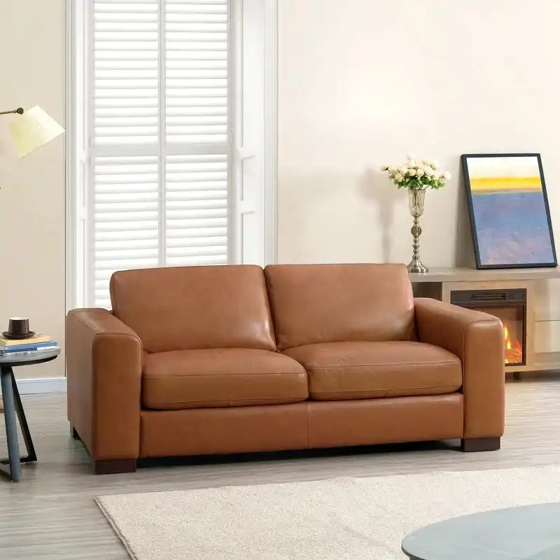 easy clean faux leather sofa with wide straight arms and thick supportive cushions — close view showing the cushion and su...