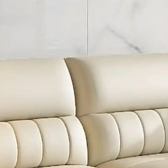 cream high back sofa with vertical cushion panels, rounded arms and slim gold finish legs — close view showing the cushion...