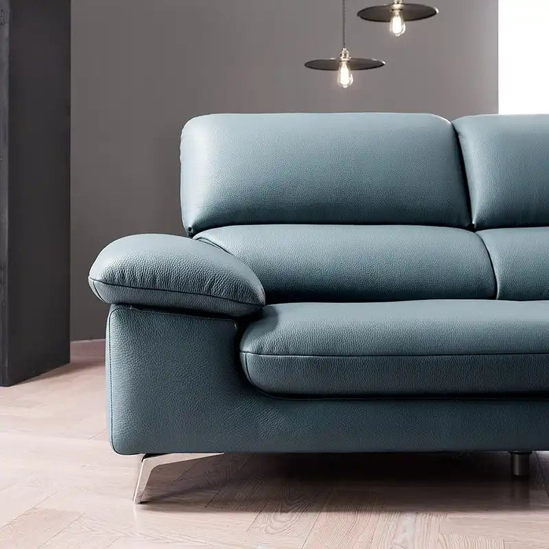 modern sofa with soft curved arms, supportive back cushions and raised chrome finish legs — close view showing the cushion...