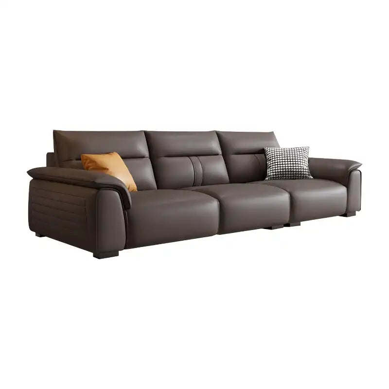 dark brown luxury sofa with broad pillow soft arms, cushioned back and detailed side panels — close view showing the cushi...