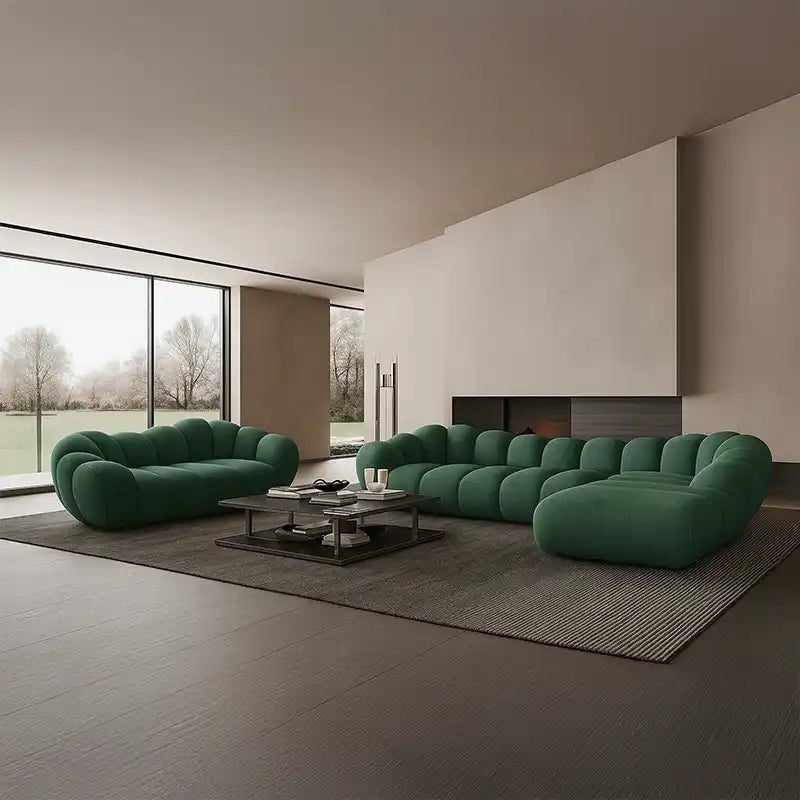 soft curved sofa with rounded cushion sections, a cloud like shape and a low relaxed base — close view showing the cushion...