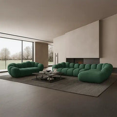 soft curved sofa with rounded cushion sections, a cloud like shape and a low relaxed base — close view showing the cushion...