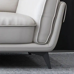 dual tone beige and charcoal fabric sofa with a soft cushioned back and deep seating — close view showing the cushion and...