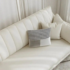 soft cream corner sofa with deep cushions, vertical back details and slim gold finish legs — close view showing the cushio...