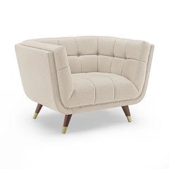 beige fabric sofa with soft curved arms, square cushion details and raised wooden legs — close view showing the cushion an...
