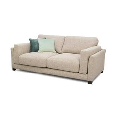 modern neutral fabric sofa with wide padded arms, thick cushions and clean straight lines — wide room view showing the com...