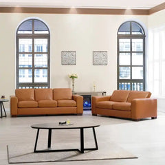 easy clean faux leather sofa with wide straight arms and thick supportive cushions — wide room view showing the complete s...