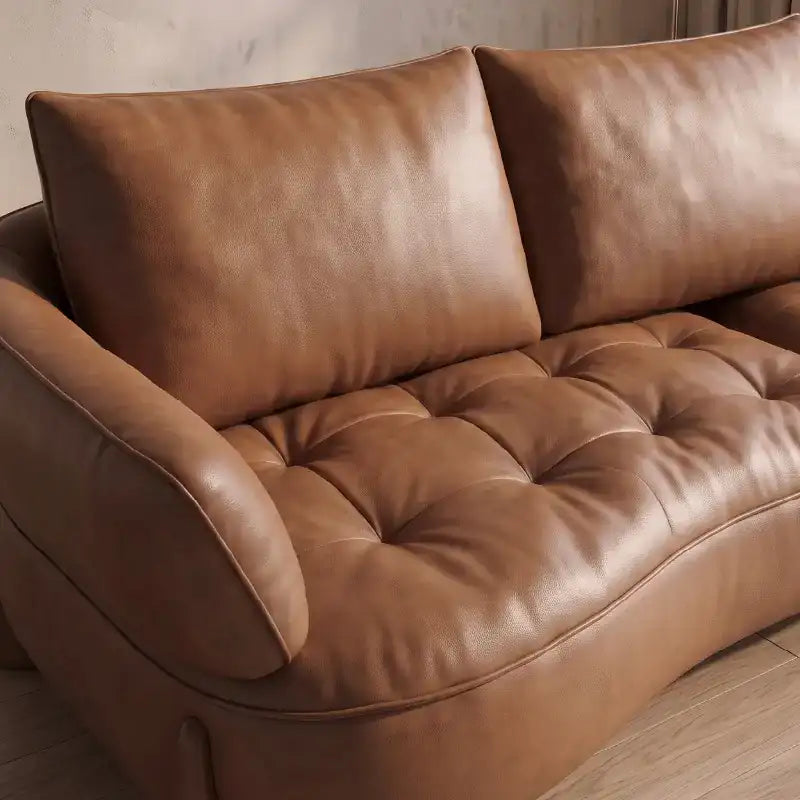 Top angle view of Omero leather sofa set with leather couch upholstery, luxury sofa appeal, sculpted wave profile, designer couch elegance and contemporary sofa design details