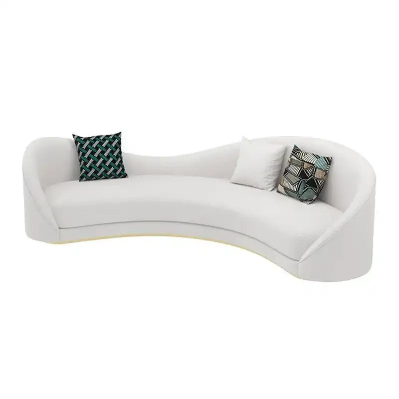 off white curved sofa with deep cushions, smooth rounded arms and soft textured fabric — wide room view showing the comple...