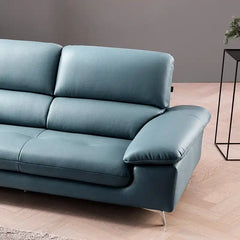 modern sofa with soft curved arms, supportive back cushions and raised chrome finish legs — wide room view showing the com...