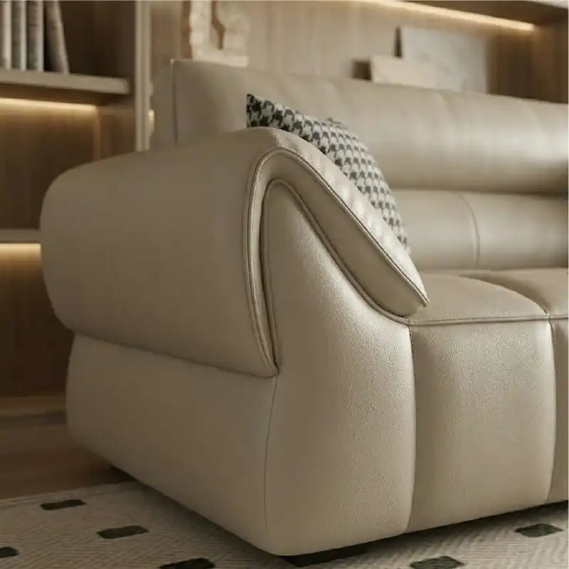 wide leatherette sofa with deep square cushioning and a low relaxed shape — wide room view showing the complete seating la...