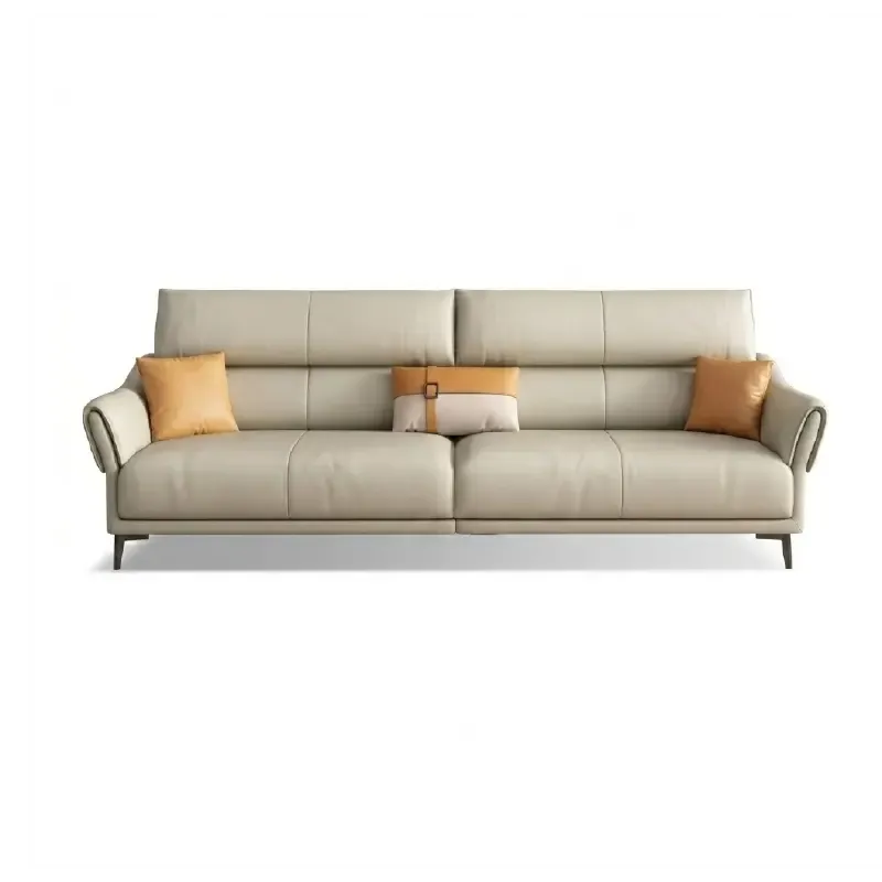 beige leatherette sofa with supportive high back cushions, rounded arms and slim raised legs — wide room view showing the...