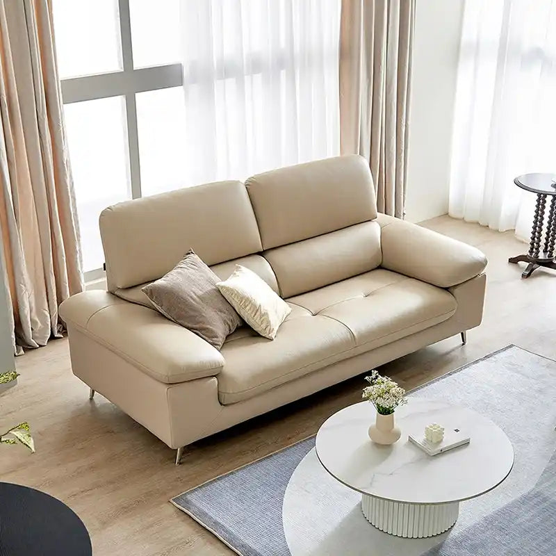 modern sofa with soft curved arms, supportive back cushions and raised chrome finish legs — front angle showing the back s...
