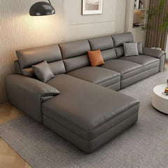 beige l shape leatherette sofa with deep seating, high back cushions and wide padded arms — front angle showing the back s...
