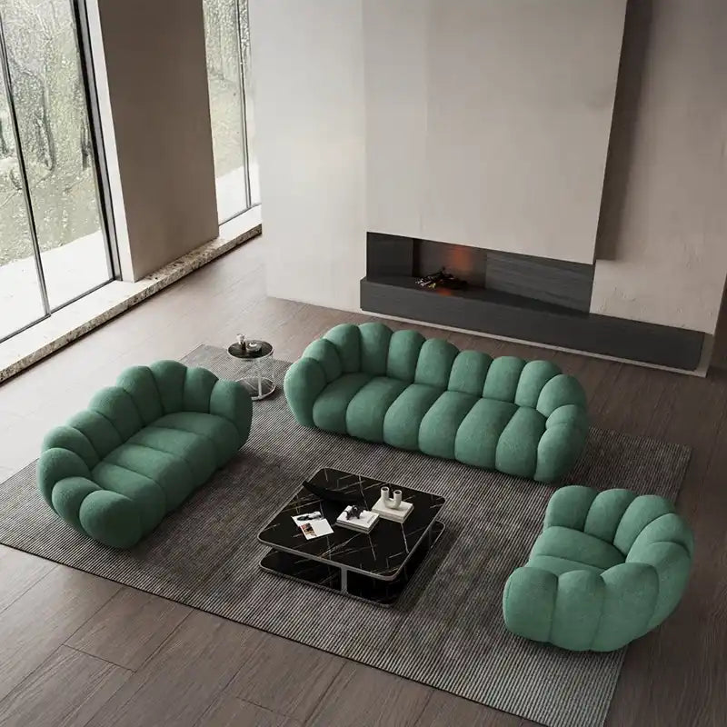 soft curved sofa with rounded cushion sections, a cloud like shape and a low relaxed base — front angle showing the back s...