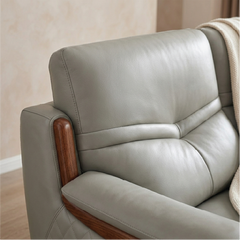 corner sofa with deep cushions, rounded arms and warm polished wooden side details — front angle showing the back support...