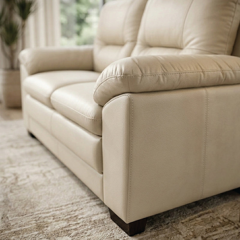 coordinated sofa set with soft cushions, broad pillow style arms and an easy clean finish — wide room view showing the com...